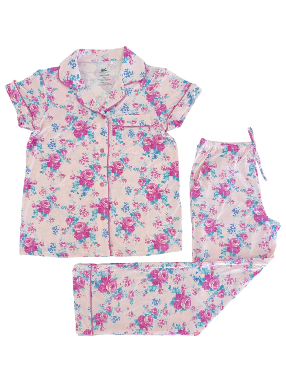 Pink floral pajama set featuring a short-sleeve button-up top and matching drawstring pants.