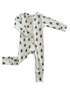 White baby onesie with green pine tree prints, featuring a front zipper and long sleeves.
