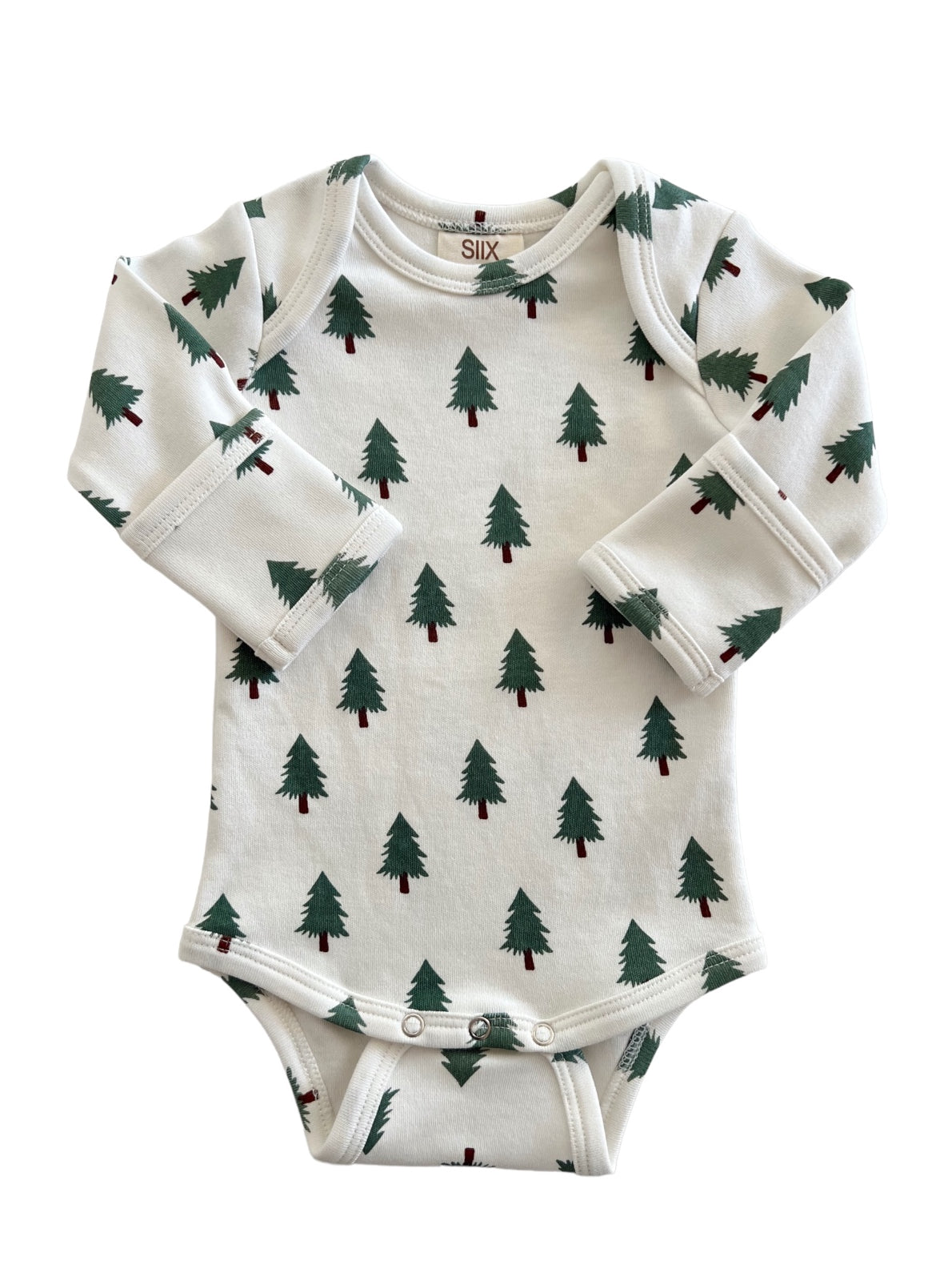 White onesie with green tree print, featuring long sleeves and snap closure at the bottom. Ideal for infants.