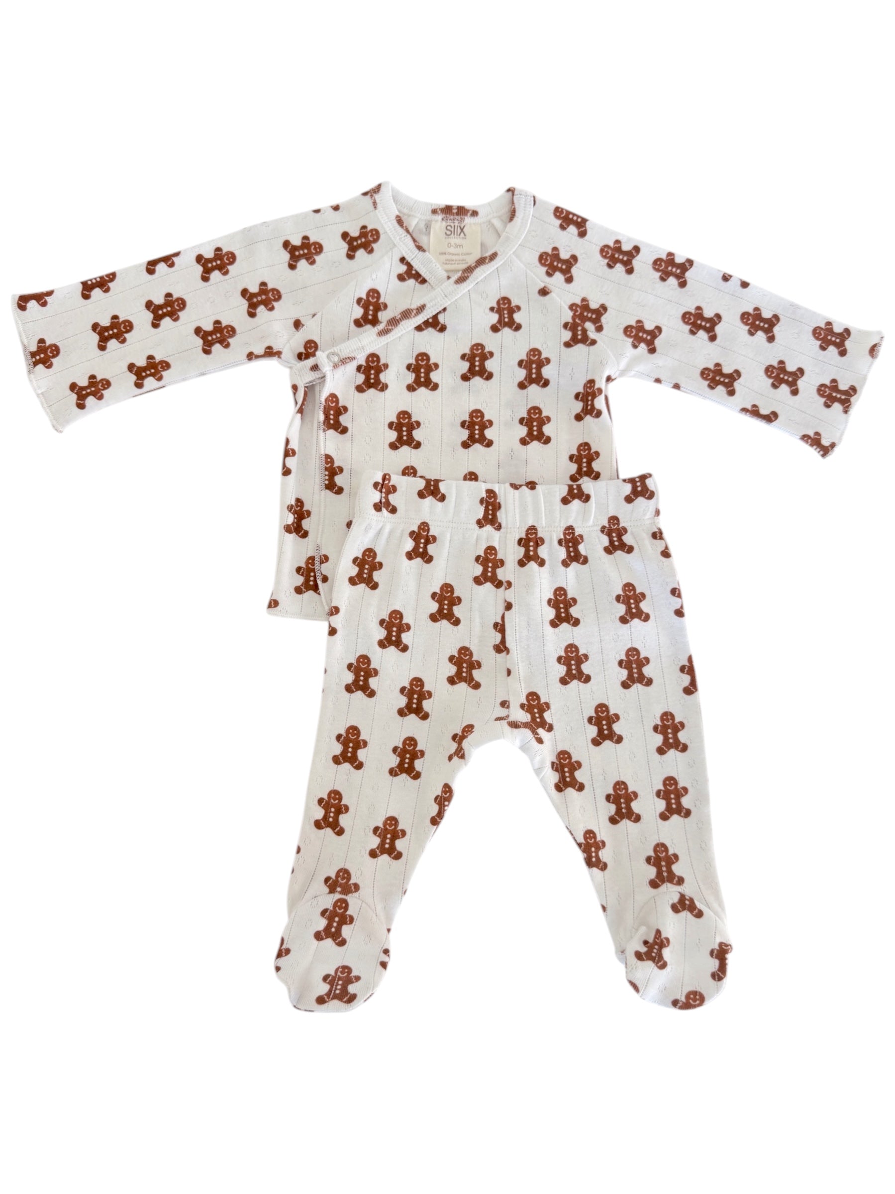 Brown and white baby outfit featuring a gingerbread man pattern, including a long-sleeve top and footed pants.