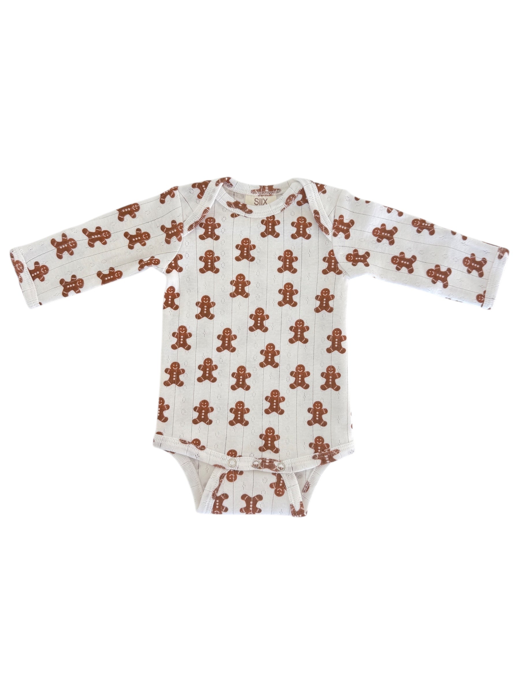 White onesie with gingerbread man print, featuring long sleeves and a snap closure at the bottom.