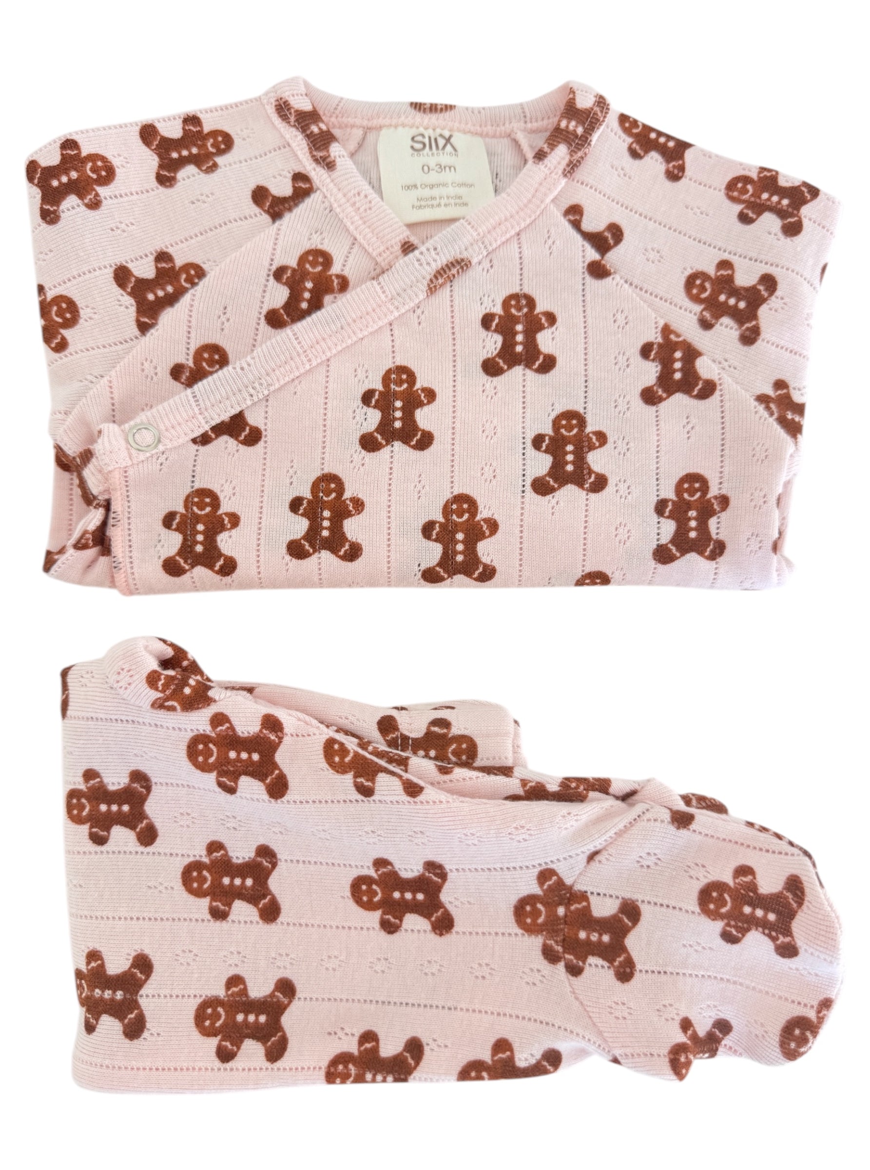 Pink baby outfit with gingerbread man pattern, including a wrap top and pants, made from 100% organic cotton.