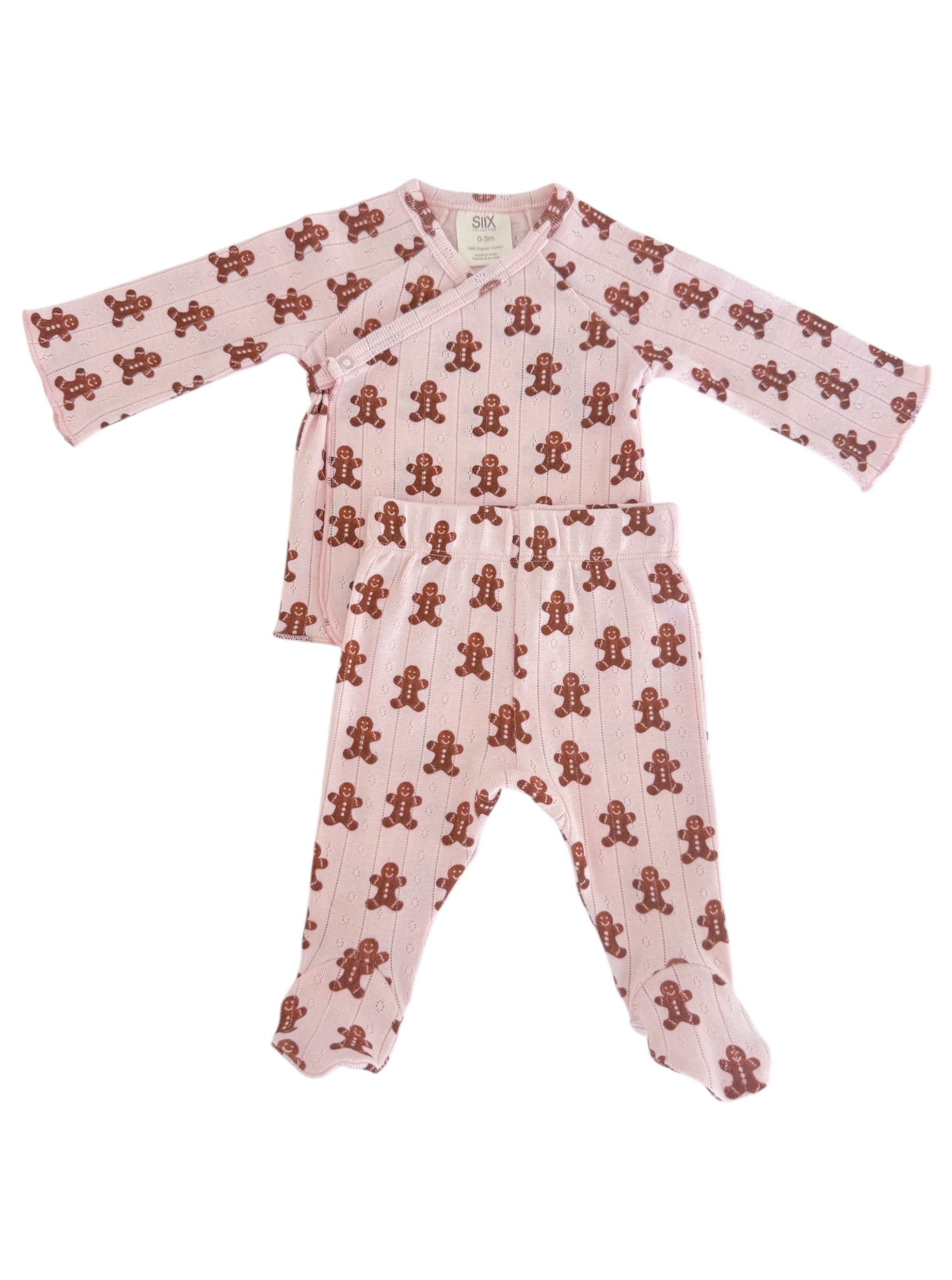 Pink baby outfit featuring a gingerbread man pattern on a long-sleeve top and matching pants.