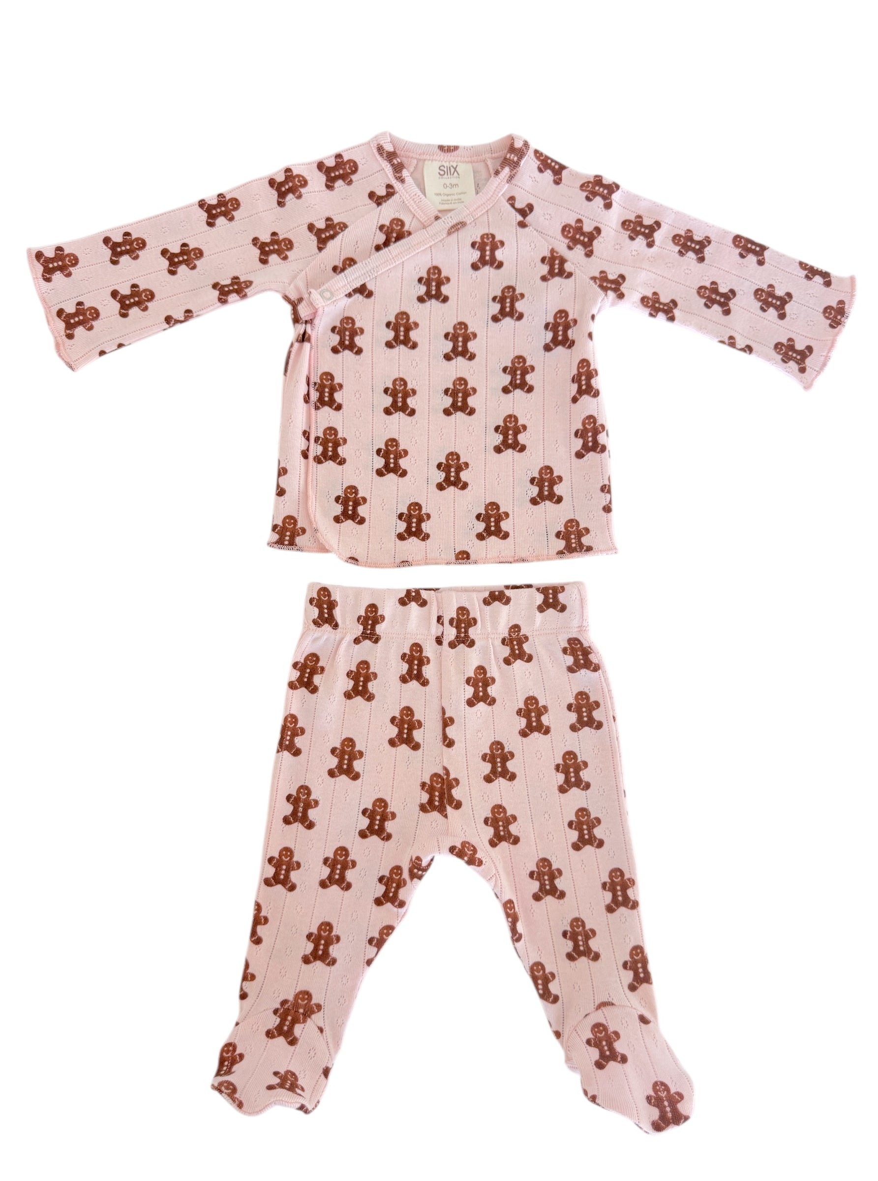 Pink toddler pajama set featuring a gingerbread man print on both the top and pants.