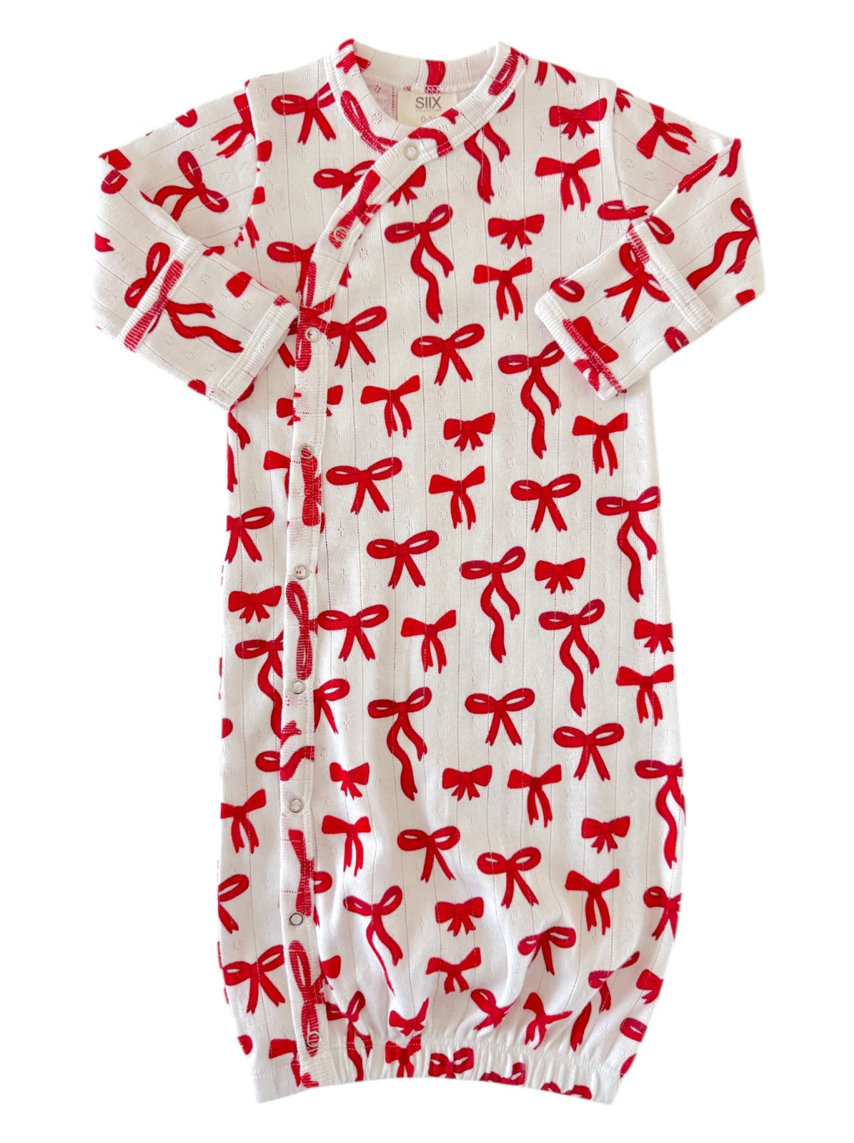 Baby gown with red bow pattern on white background, featuring short sleeves and a gathered bottom.