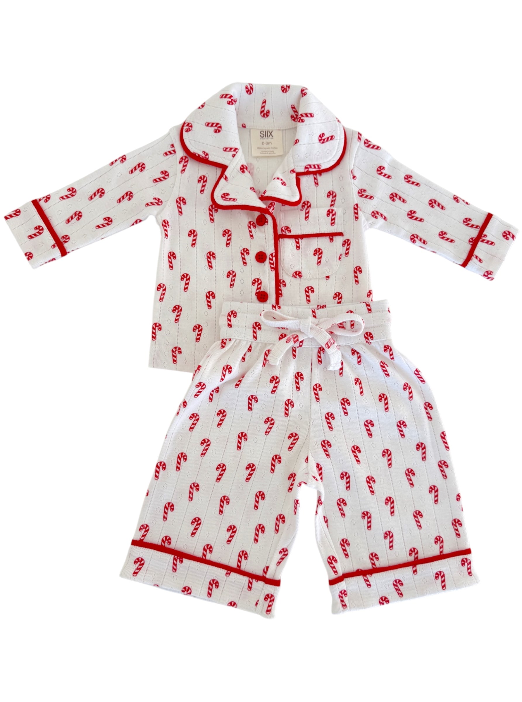 White pajama set with red candy cane design, featuring a collar and contrasting trim.