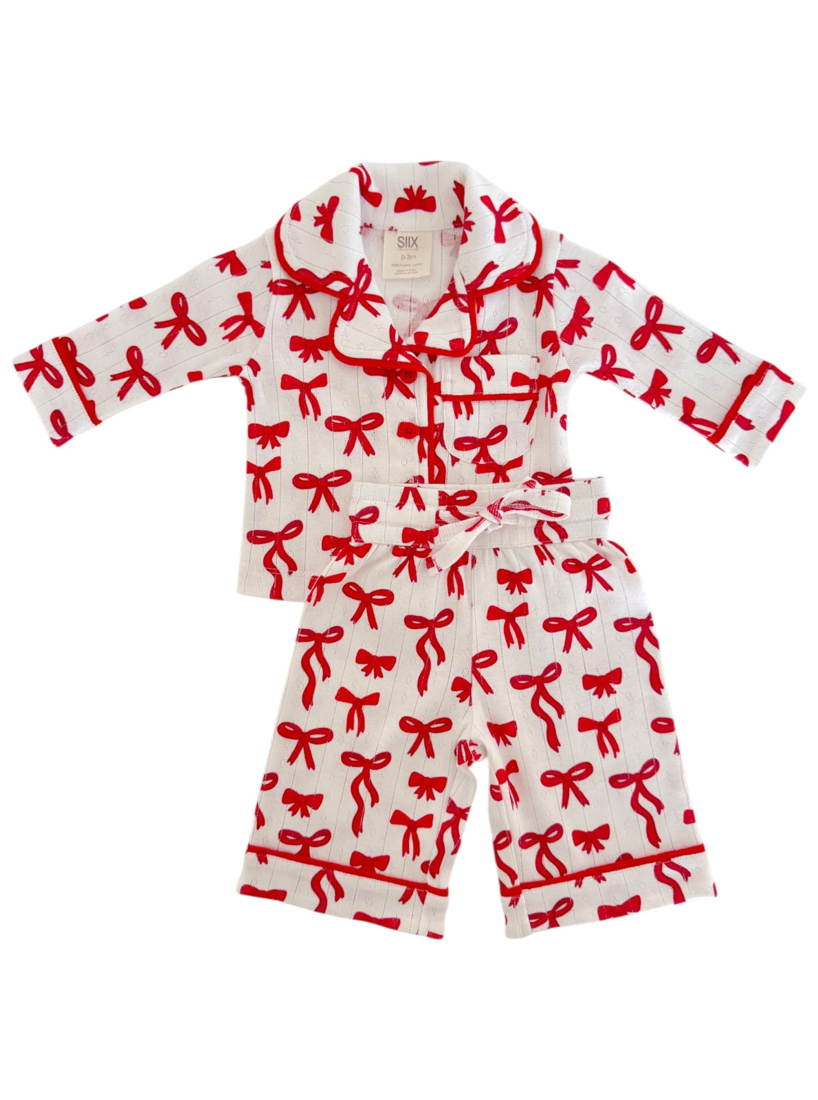 Red bow pattern cotton children's pajama set including a long-sleeve top and matching pants.