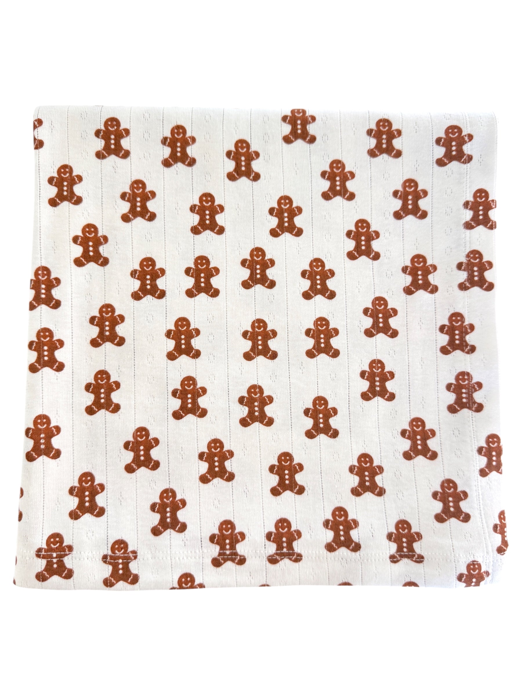 Patterned fabric featuring repeating gingerbread man designs in brown on a light background.