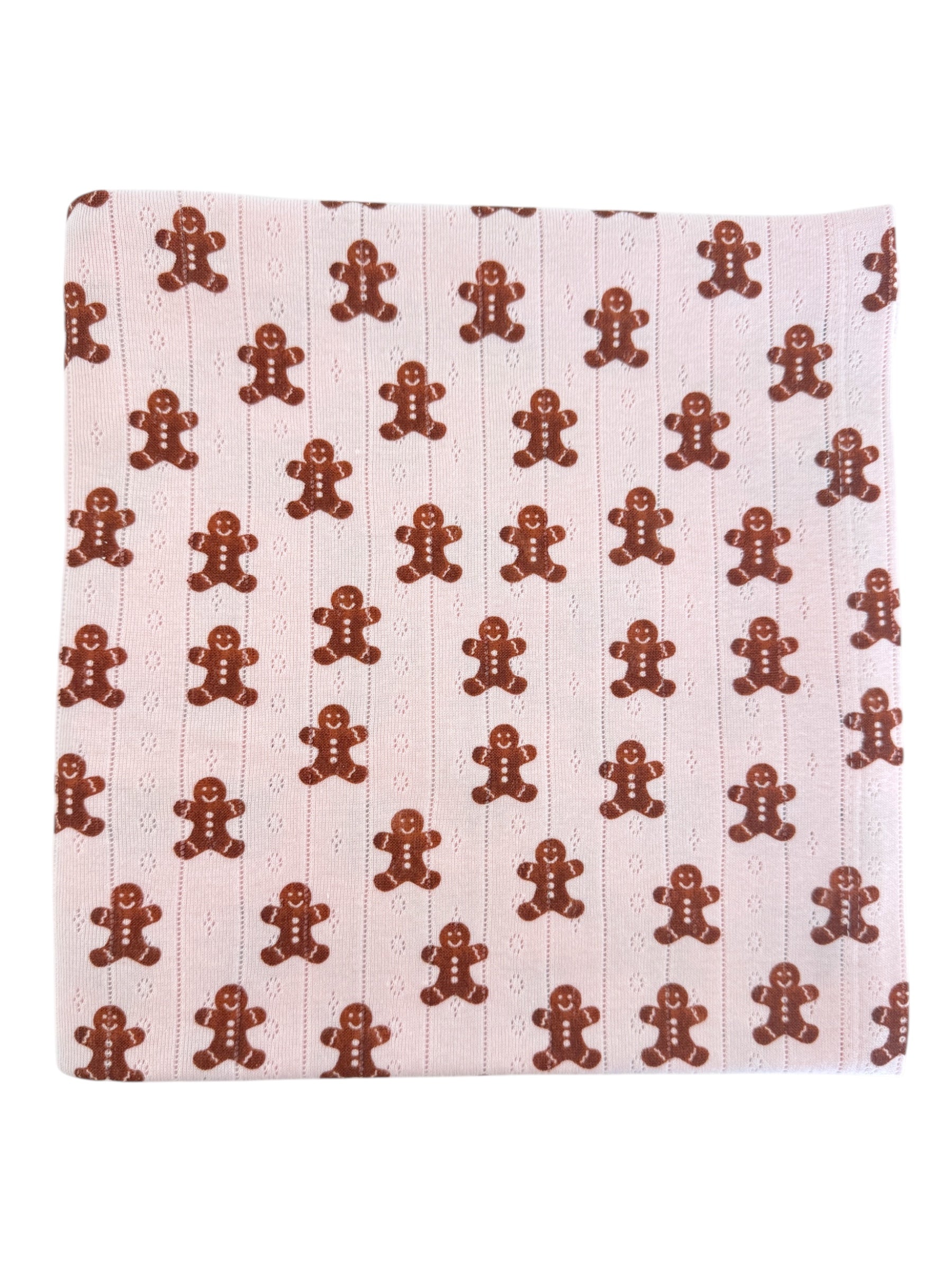 Gingerbread cookie pattern on a light pink background. Fun and festive textile design.