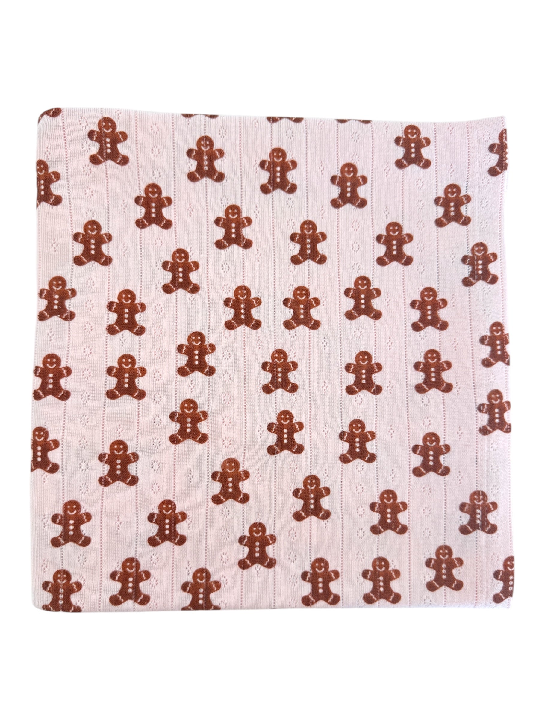 Gingerbread cookie pattern on a light pink background. Fun and festive textile design.