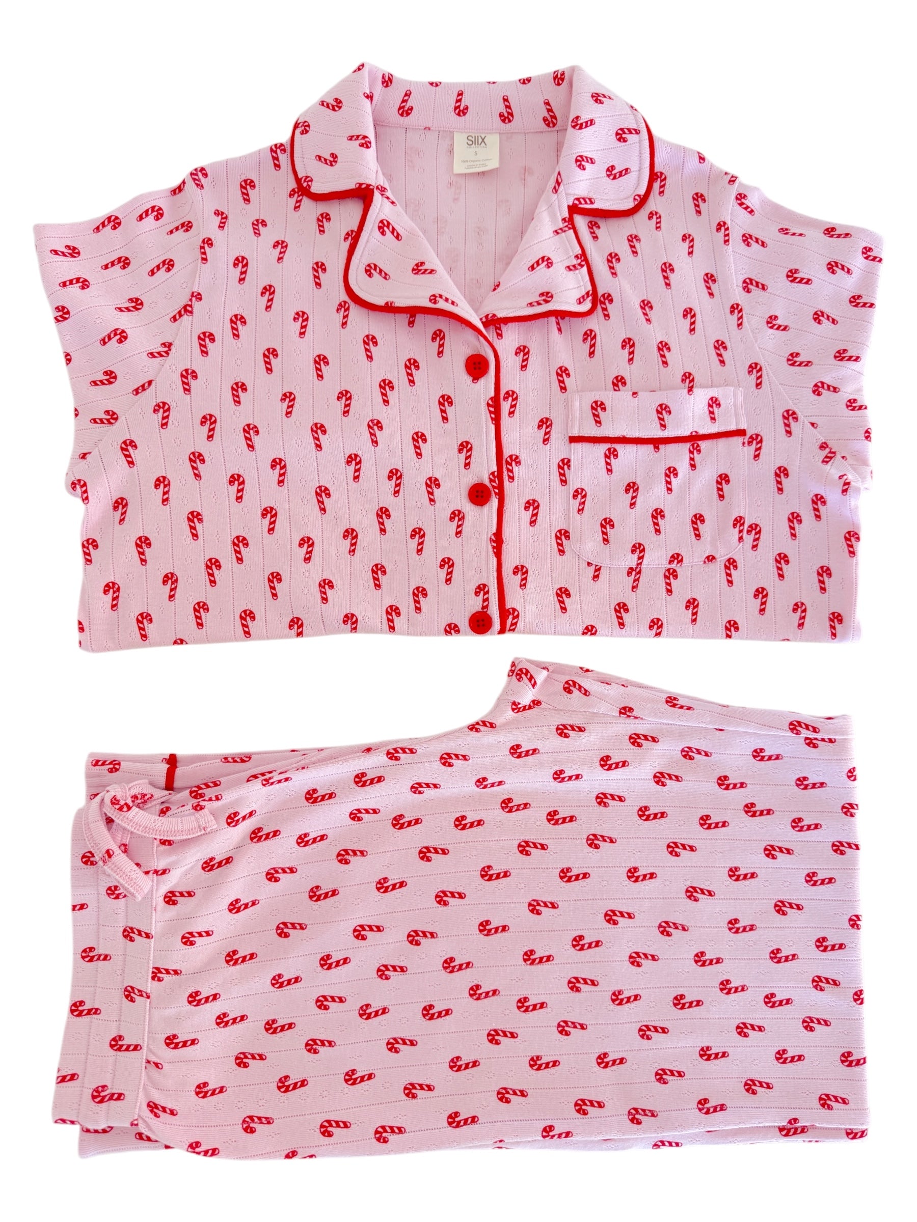 Pink pajama set with red candy cane patterns, featuring a short-sleeved top and matching pants.