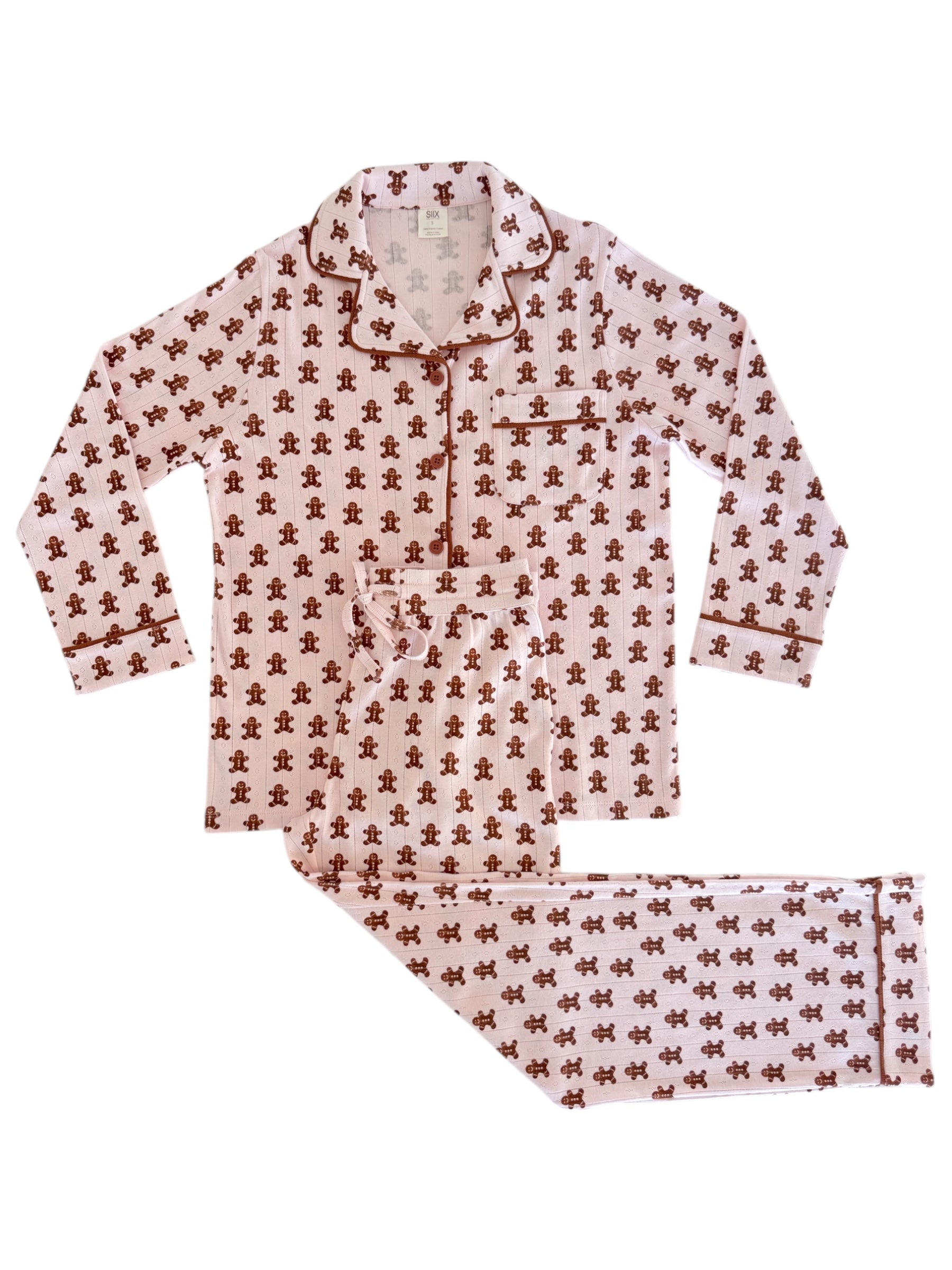 Pink pajama set featuring a gingerbread man print, including long-sleeve top and matching pants.