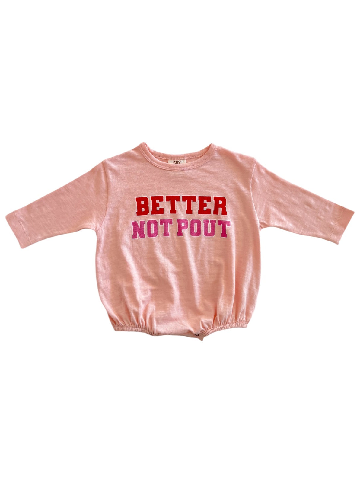 Pink long-sleeve shirt with the text "BETTER NOT POUT" in red and pink letters across the front.