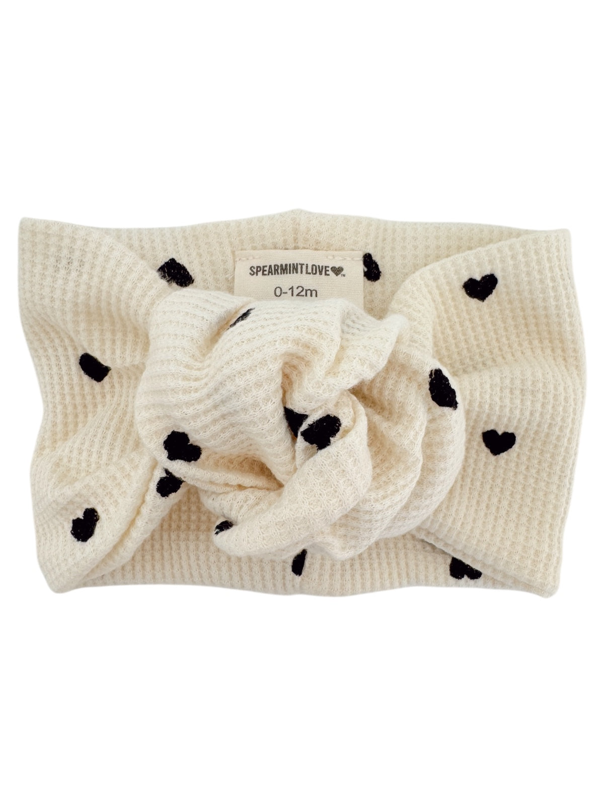 Cream headband with black heart patterns, labeled "SPEARMINTLOVE" for ages 0-12 months.