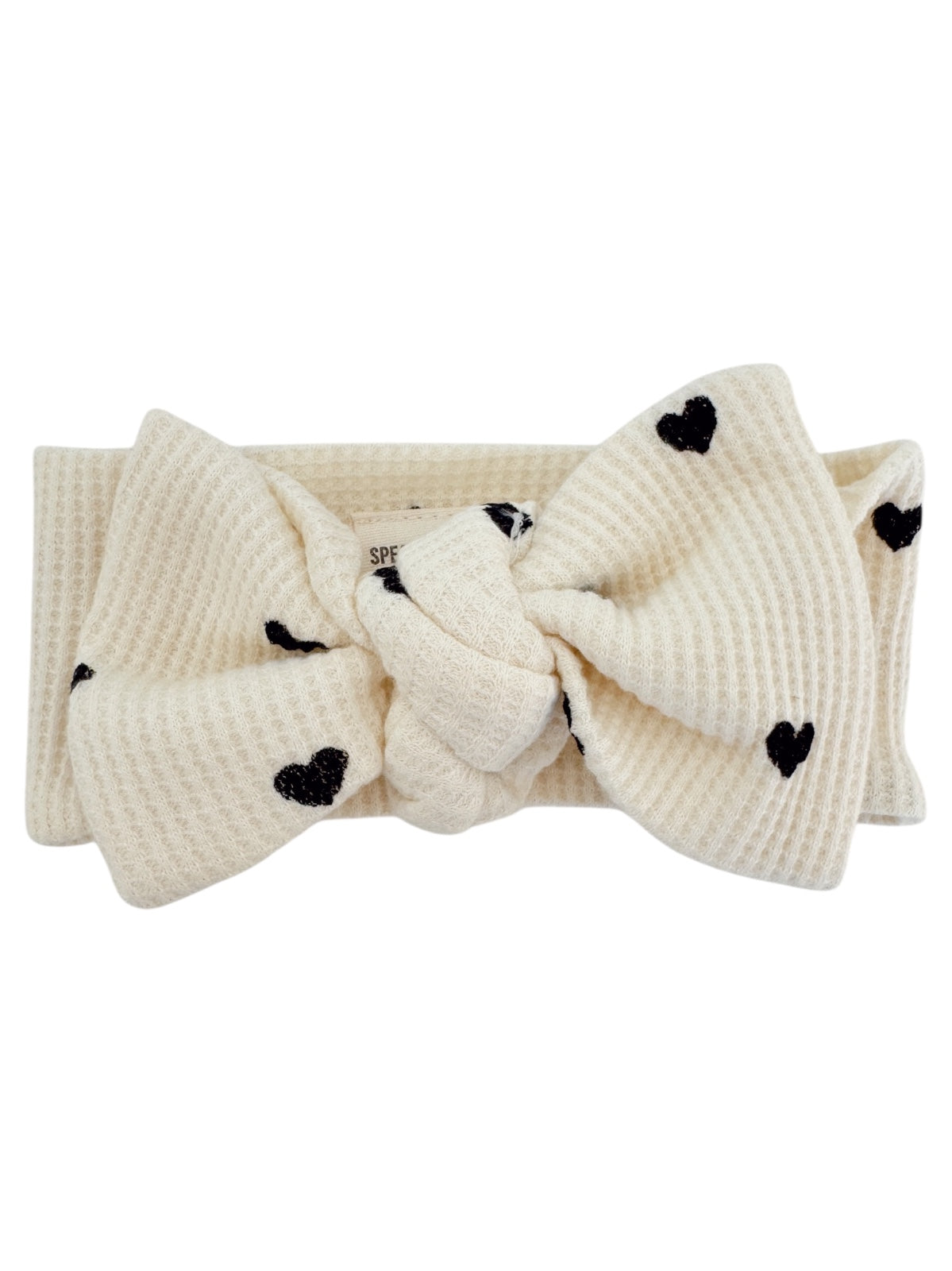Cream-colored headband with a large bow and black heart patterns. Ideal for stylish hair accessories.