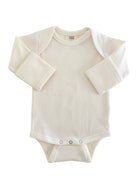 Cream-colored baby bodysuit with long sleeves and snap closures at the bottom. Soft ribbed texture.