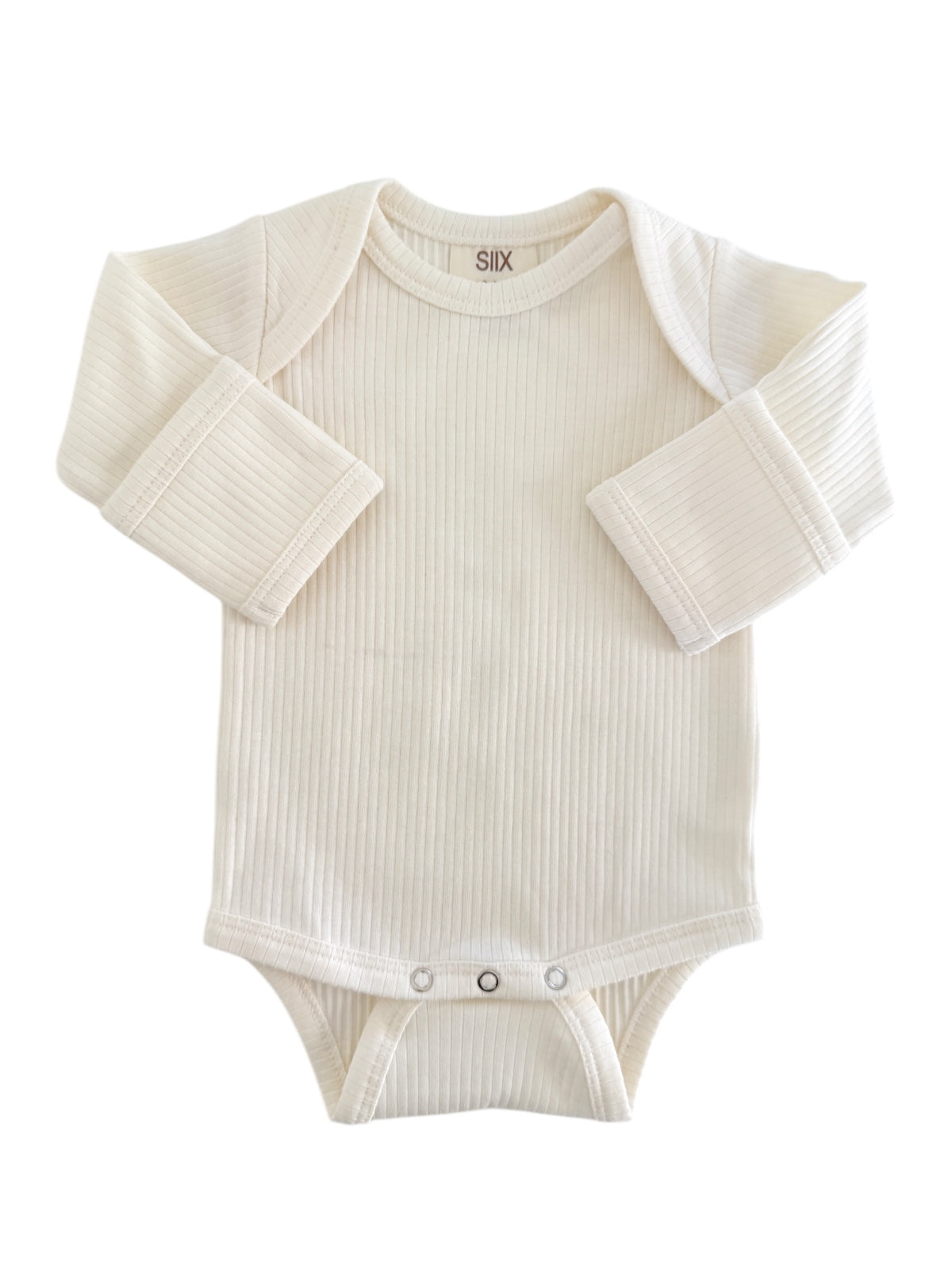 Cream-colored baby bodysuit with long sleeves and snap closures at the bottom. Soft ribbed texture.