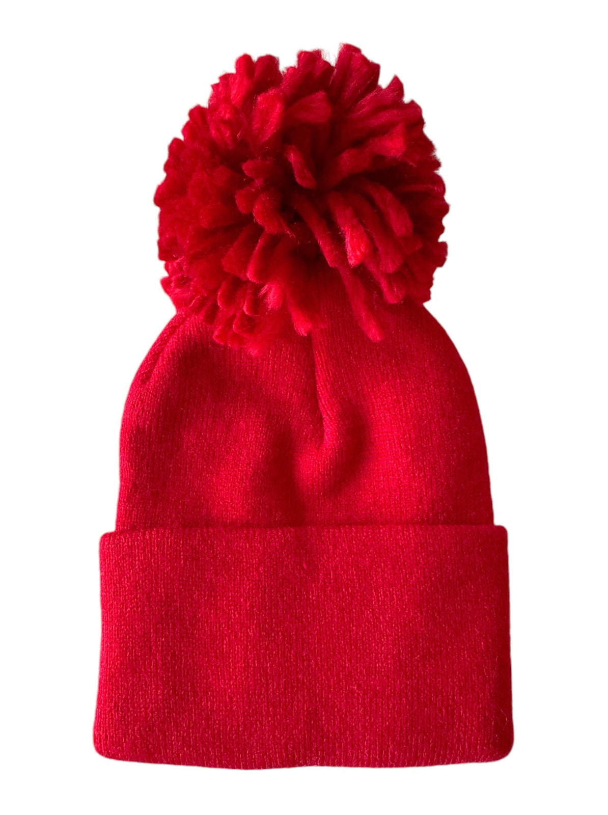 Red knit beanie hat with a fluffy pom-pom on top. Perfect for winter wear and outdoor activities.
