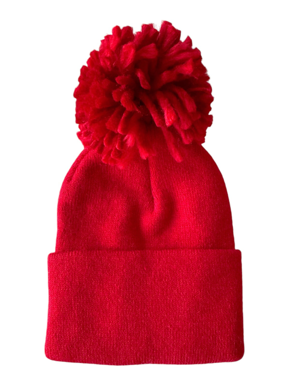 Red knit beanie hat with a fluffy pom-pom on top. Perfect for winter wear and outdoor activities.