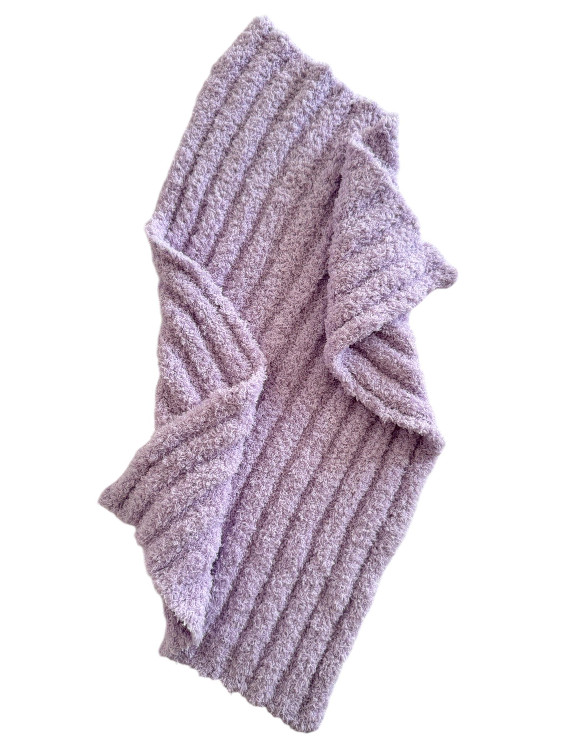 Soft lavender ribbed blanket with cozy texture, draped elegantly to showcase its design and warmth.