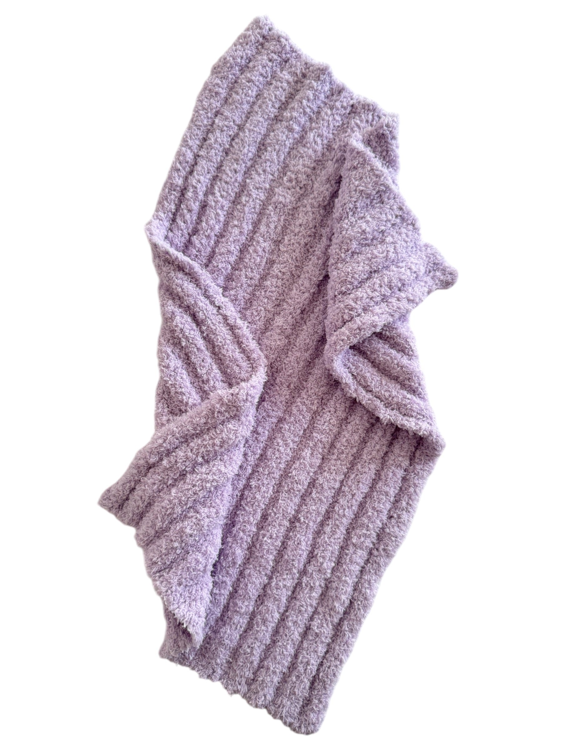 Soft lavender ribbed blanket with cozy texture, draped elegantly to showcase its design and warmth.
