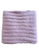 Soft lavender plush blanket with textured ribbed pattern. Perfect for cozying up or adding comfort to any space.