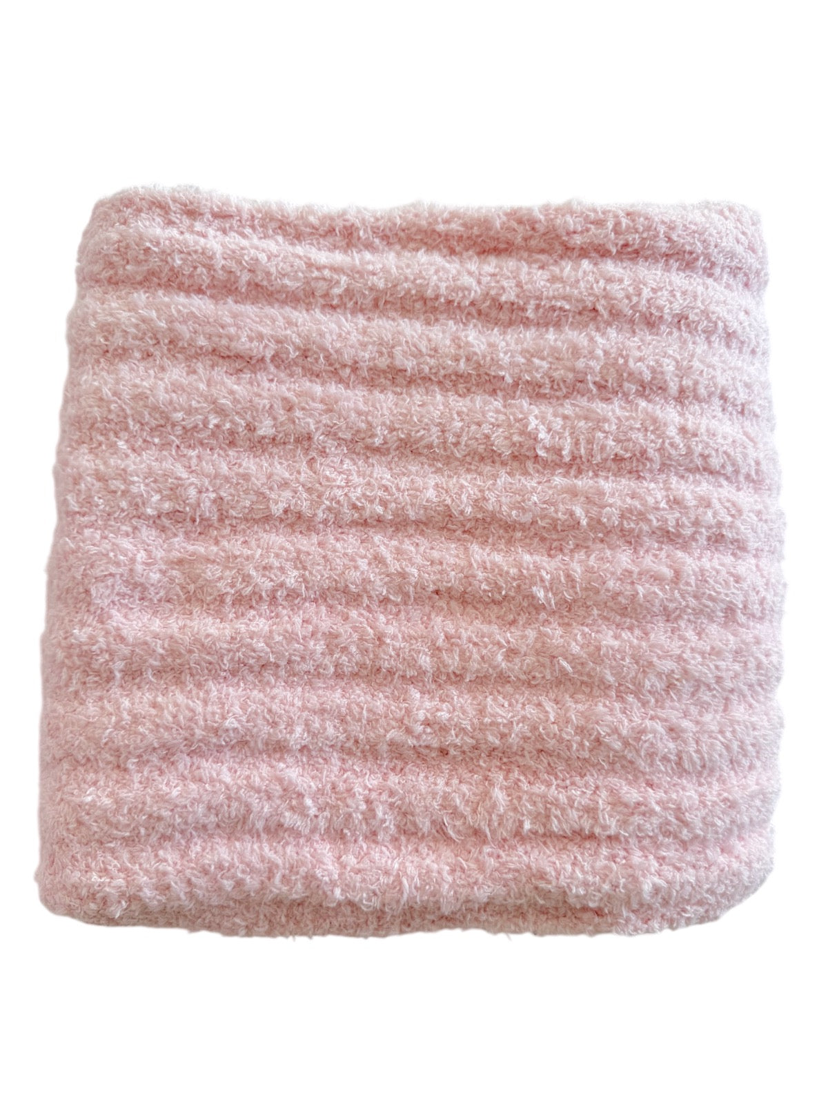 Soft pink textured blanket folded neatly.