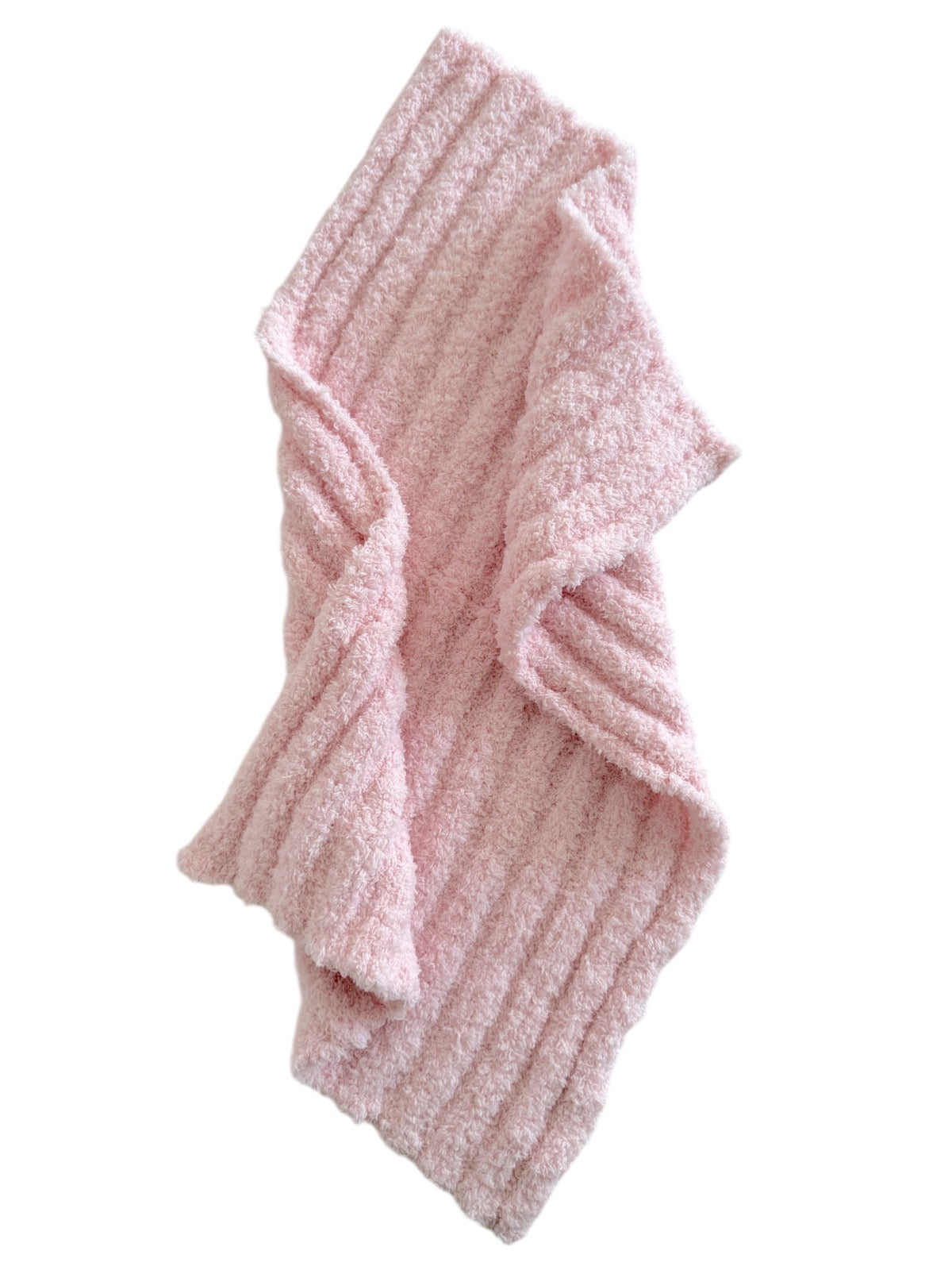 Soft pink, ribbed blanket folded casually on a white background, suggesting warmth and comfort.