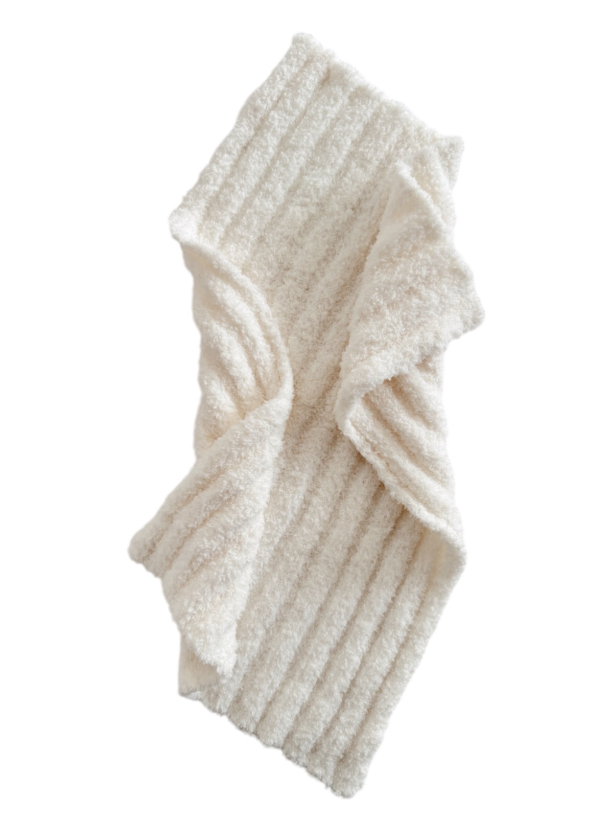Cream-colored textured blanket draped elegantly, showcasing its soft, ribbed design. Ideal for cozy home décor.