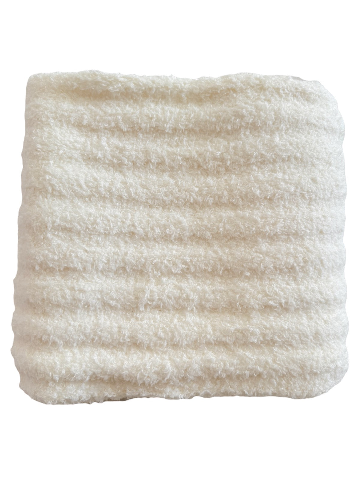 Soft, cream-colored blanket with a textured, ribbed pattern.