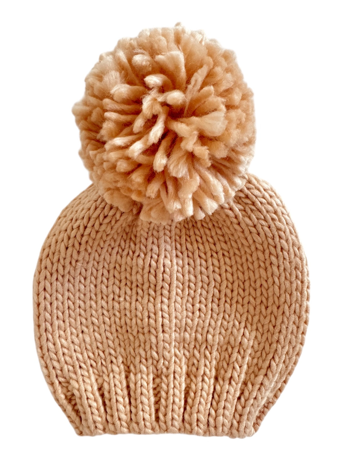 Light beige knitted beanie hat with a fluffy pom-pom on top. Ideal for winter wear and stylish outfits.