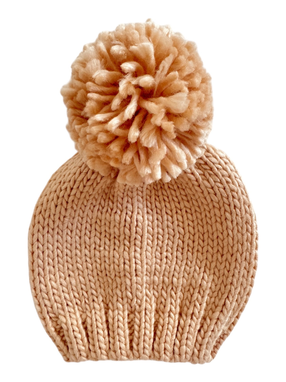 Light beige knitted beanie hat with a fluffy pom-pom on top. Ideal for winter wear and stylish outfits.