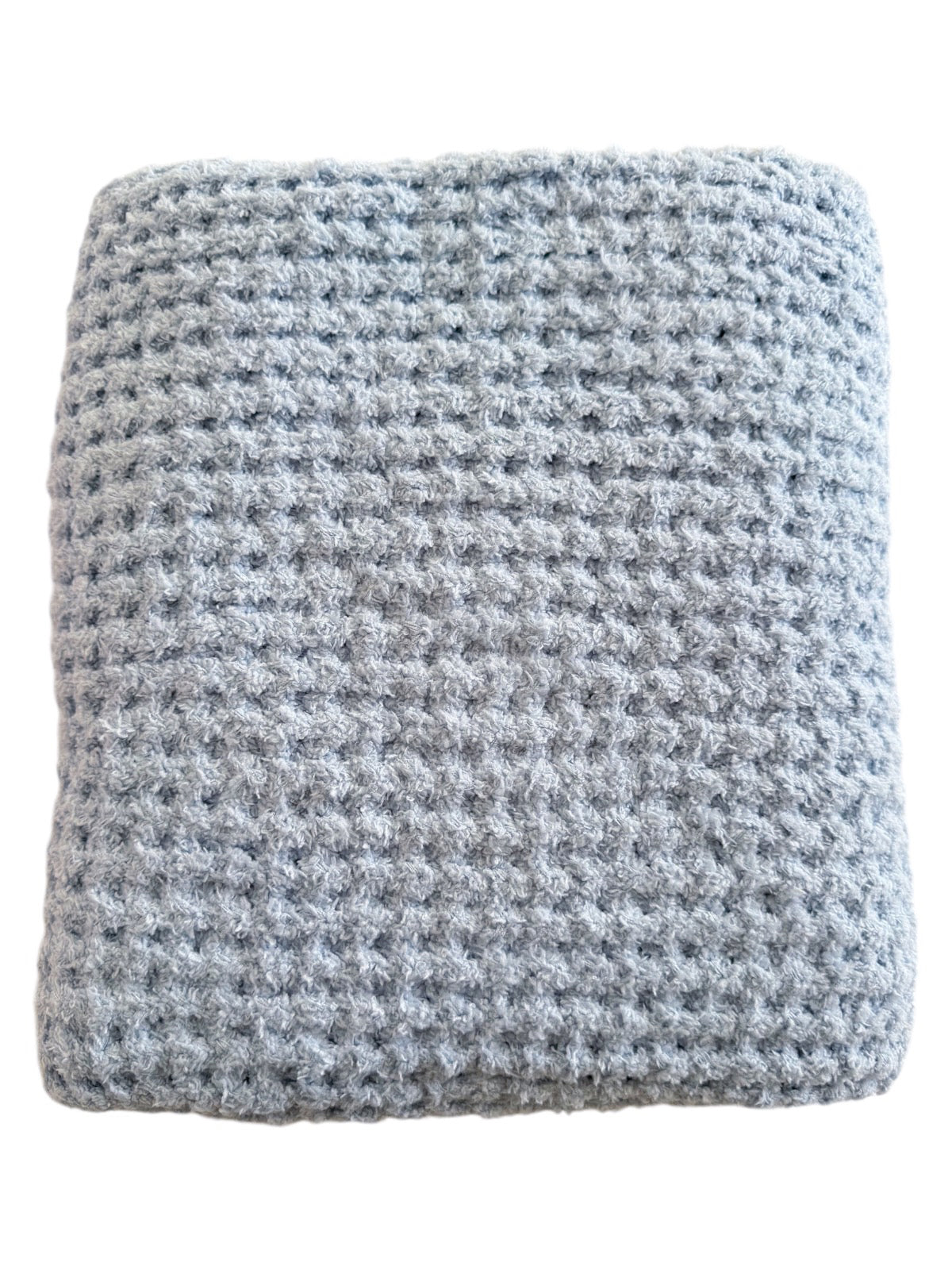 Gray textured blanket folded neatly, showcasing its soft, plush fabric and intricate weave pattern.