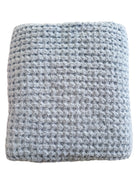 Gray textured blanket folded neatly, showcasing its soft, plush fabric and intricate weave pattern.
