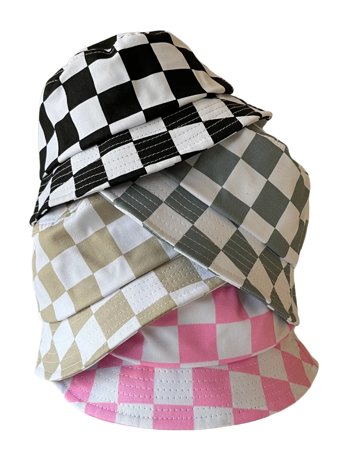A stack of four checkered bucket hats in black, white, gray, and pink.
