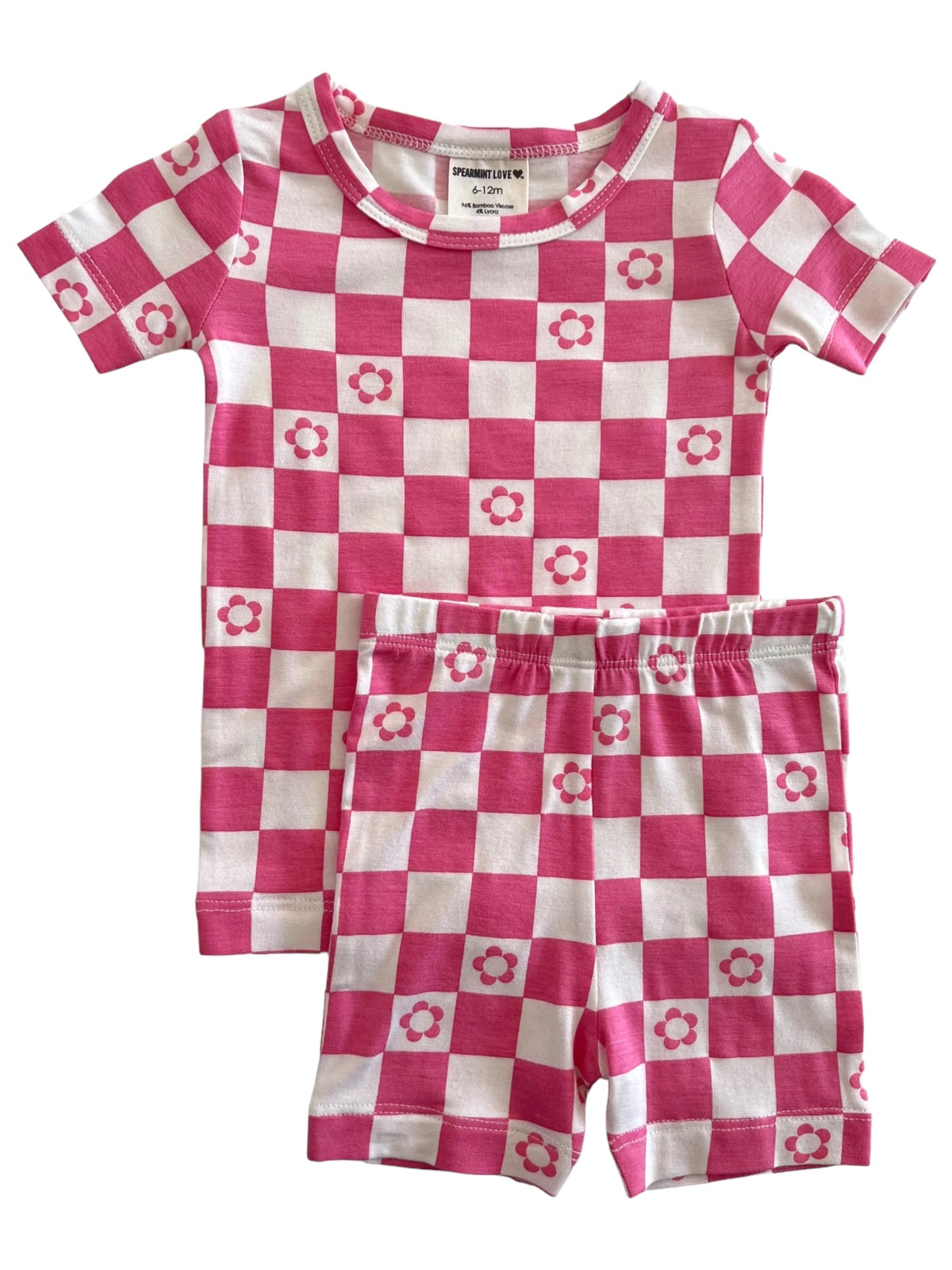 Pink and white checkered toddler pajamas with floral designs, featuring a short-sleeve shirt and shorts.
