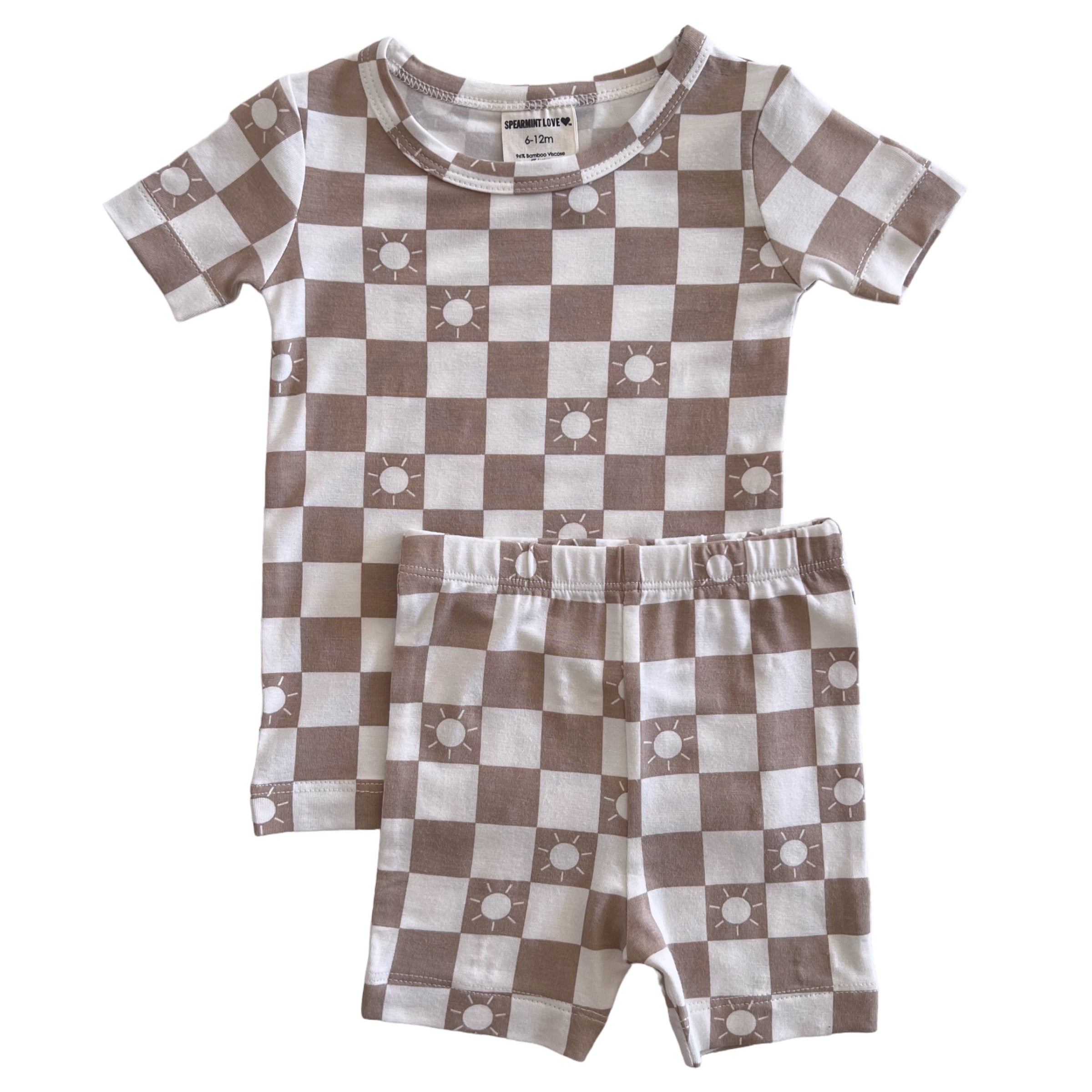 Brown and white checked toddler pajamas with sun pattern on top and shorts. Suitable for ages 6 to 12 months.