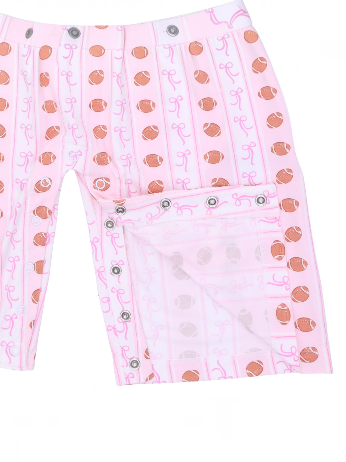 Pink shorts featuring football and bow patterns, with snap closure details on the side.