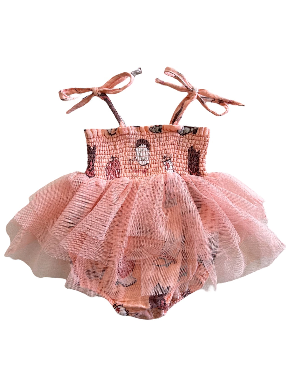 Pink baby dress with a fitted top and layered tulle skirt, featuring whimsical prints and tie straps.