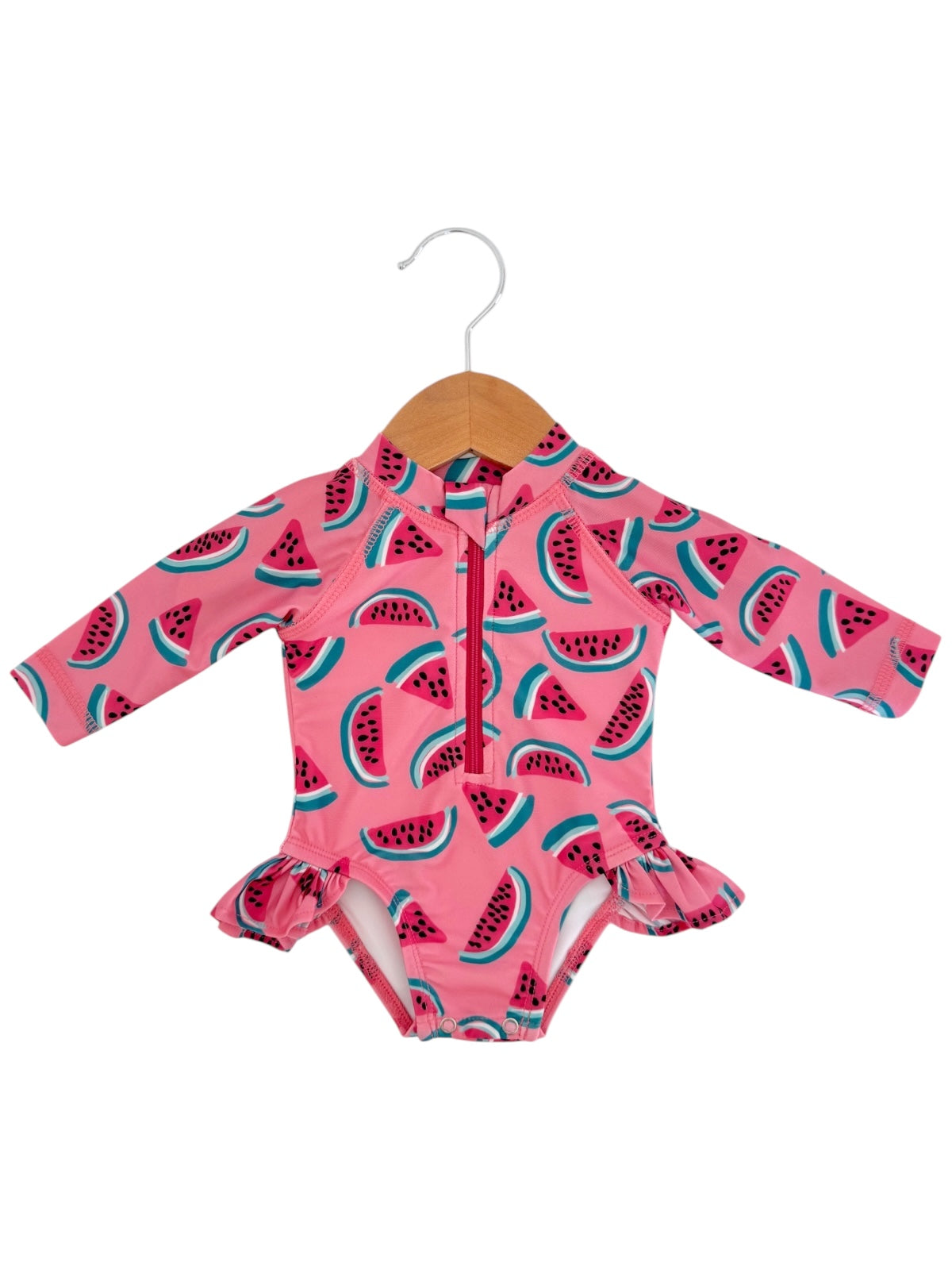 Pink long-sleeve swimsuit with watermelon print, featuring a front zipper and ruffled hem. Suitable for children.