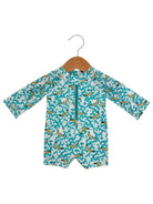 Children's swim romper with banana print, hanging on a wooden hanger against a white background.