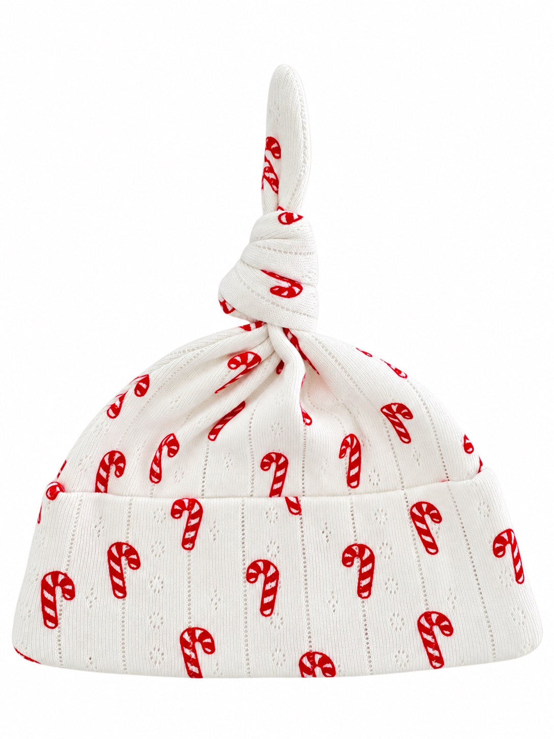 White baby hat with a knot on top, adorned with red candy cane patterns.