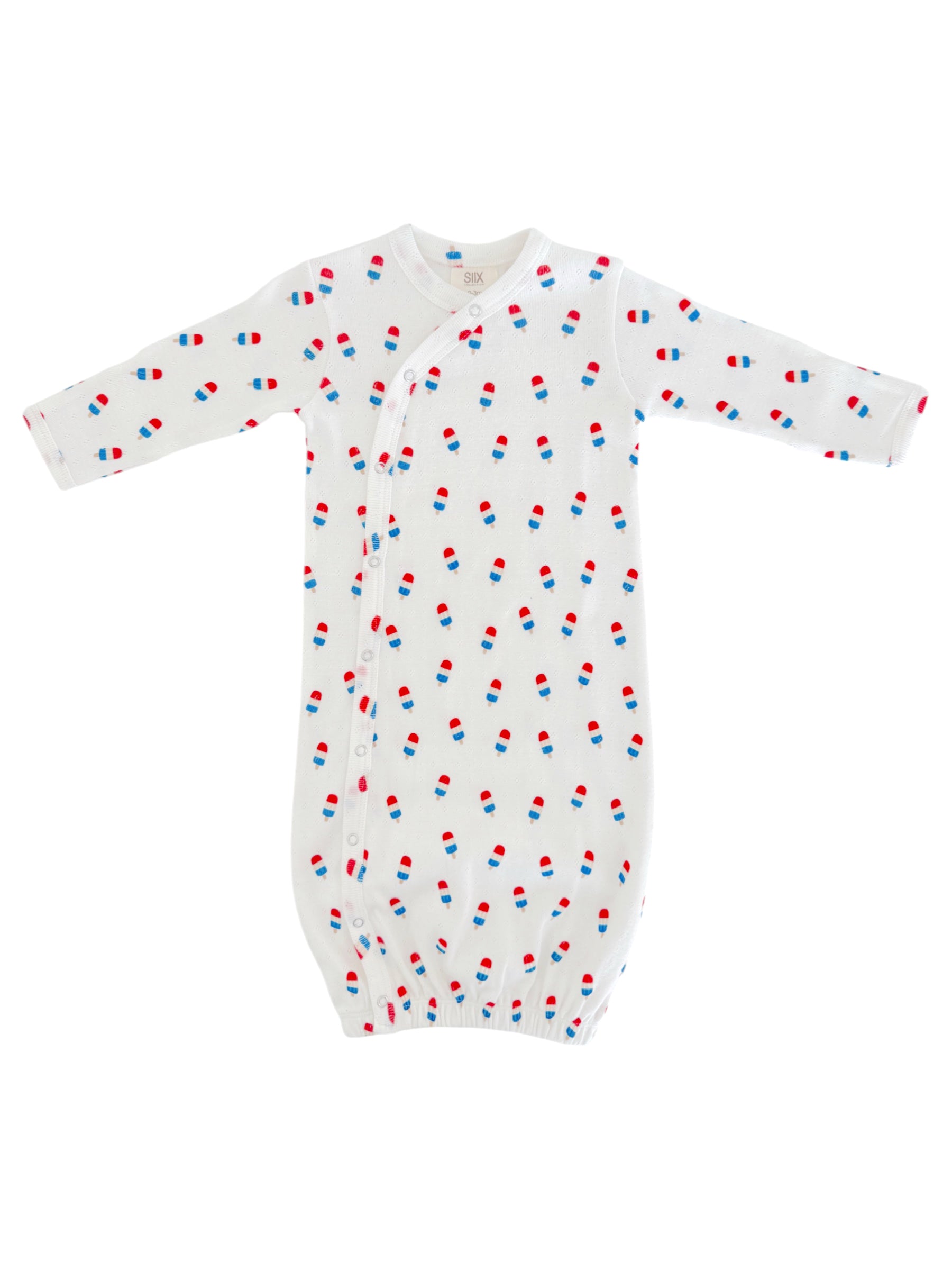 White baby gown with colorful pill print, featuring long sleeves and snap closures at the front.