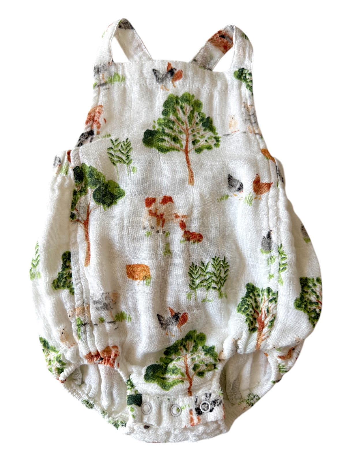 White baby romper with colorful animal and tree patterns, showcasing a playful, nature-inspired design.