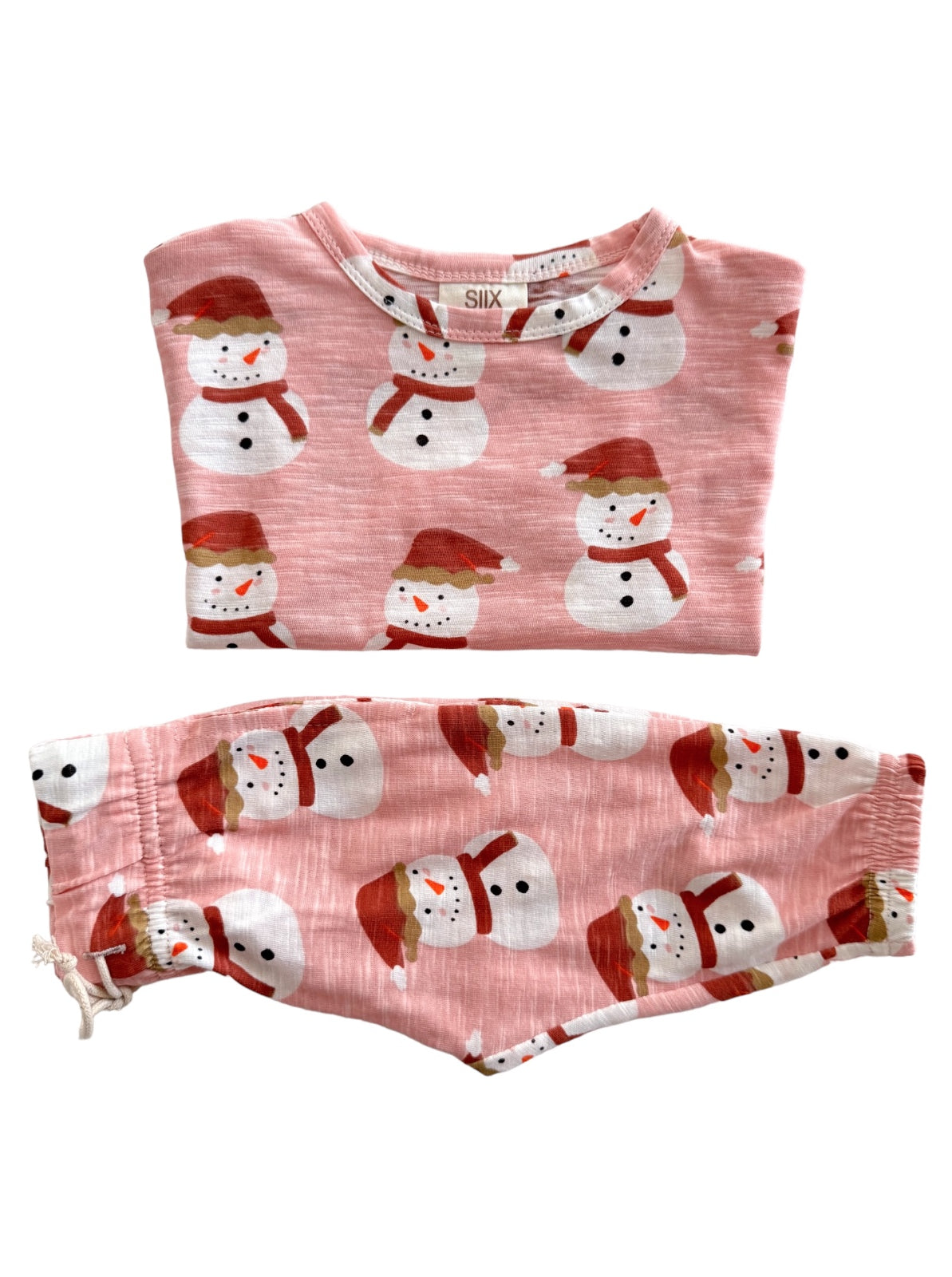 Pink pajama set featuring snowman patterns, including a top and matching bottoms with festive hats and scarves.