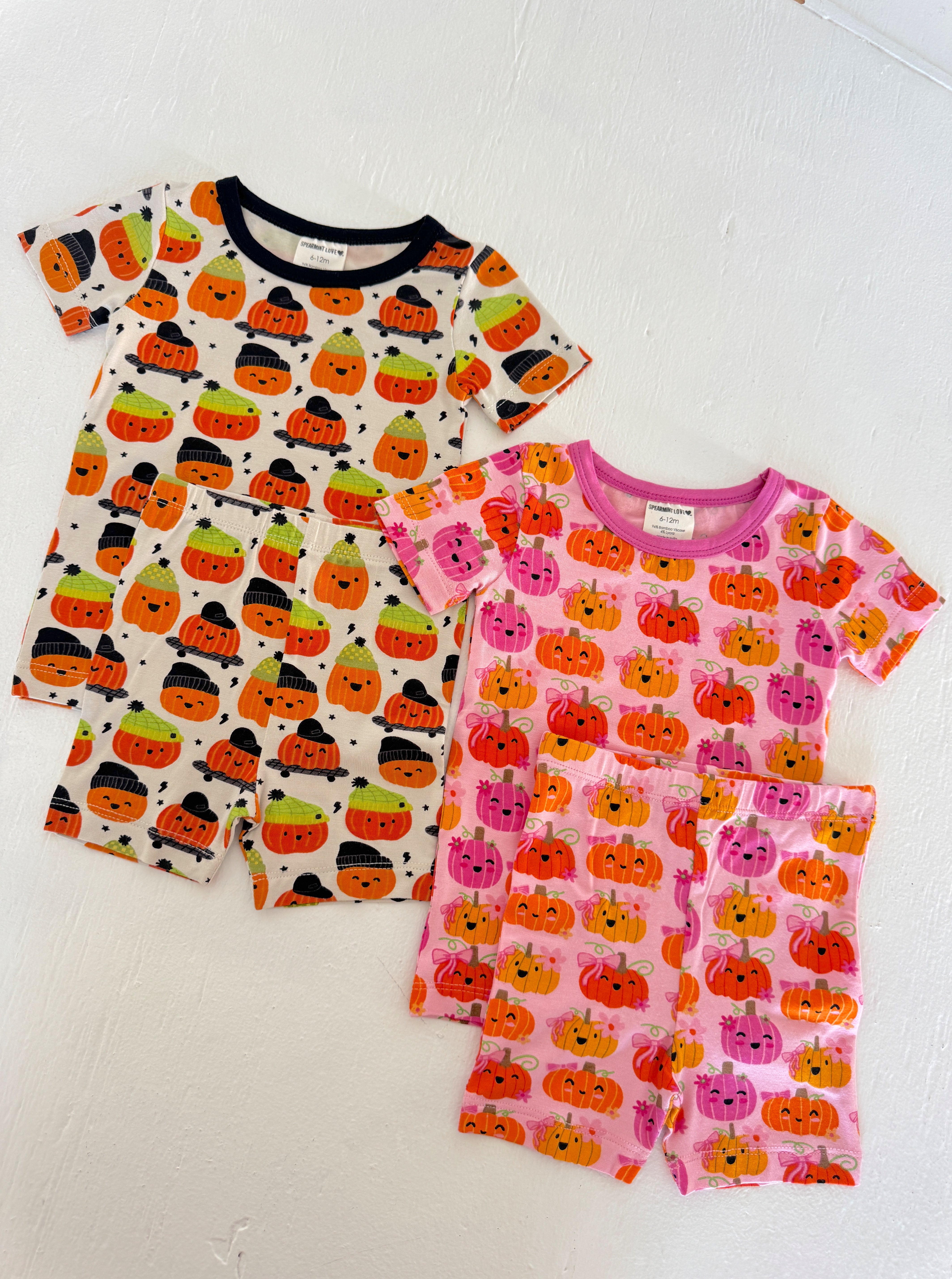 Two sets of toddler pajamas featuring colorful pumpkin designs, ideal for Halloween festivities.