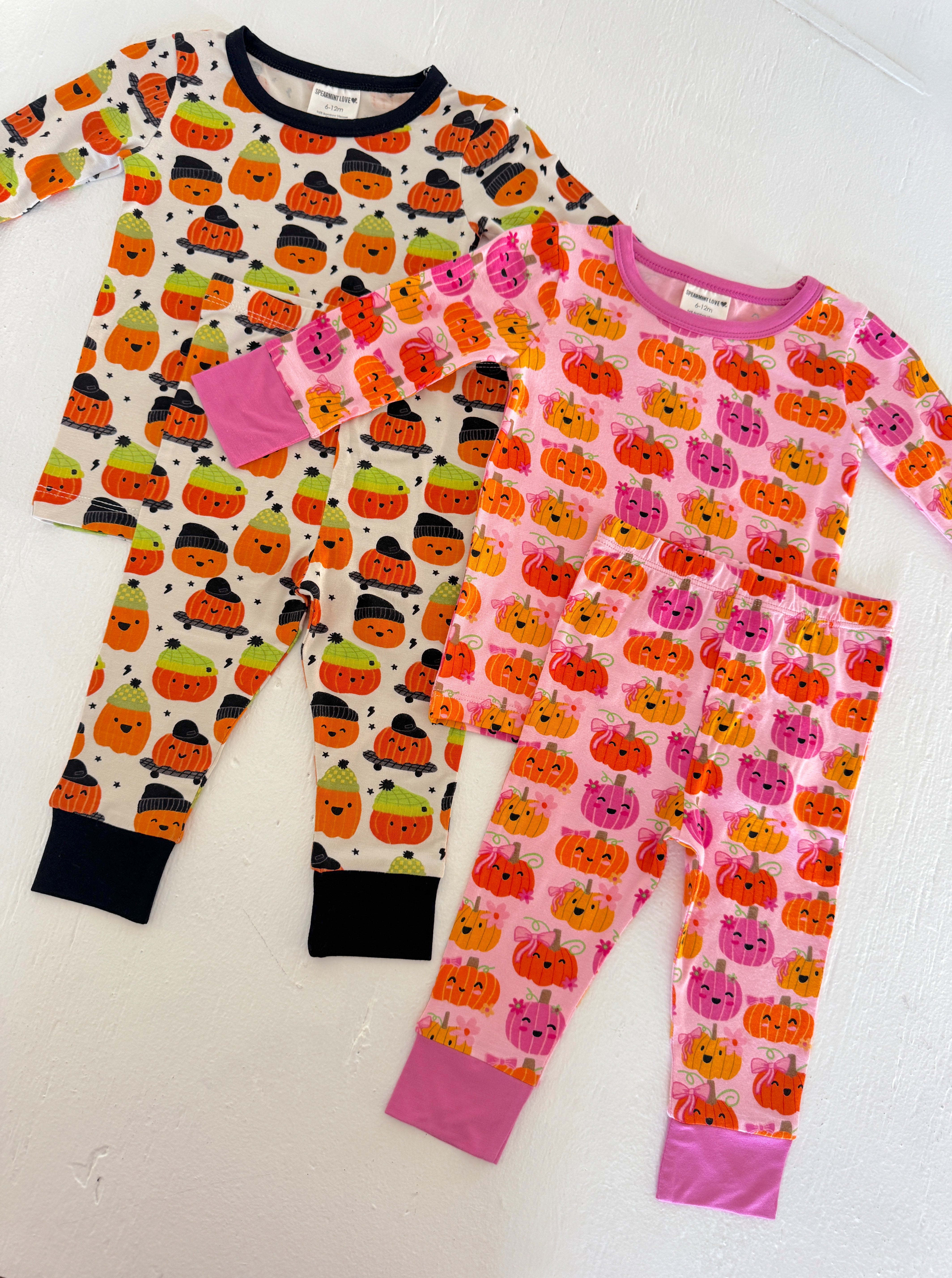 Three pairs of colorful Halloween-themed pajamas featuring pumpkin designs in various patterns.