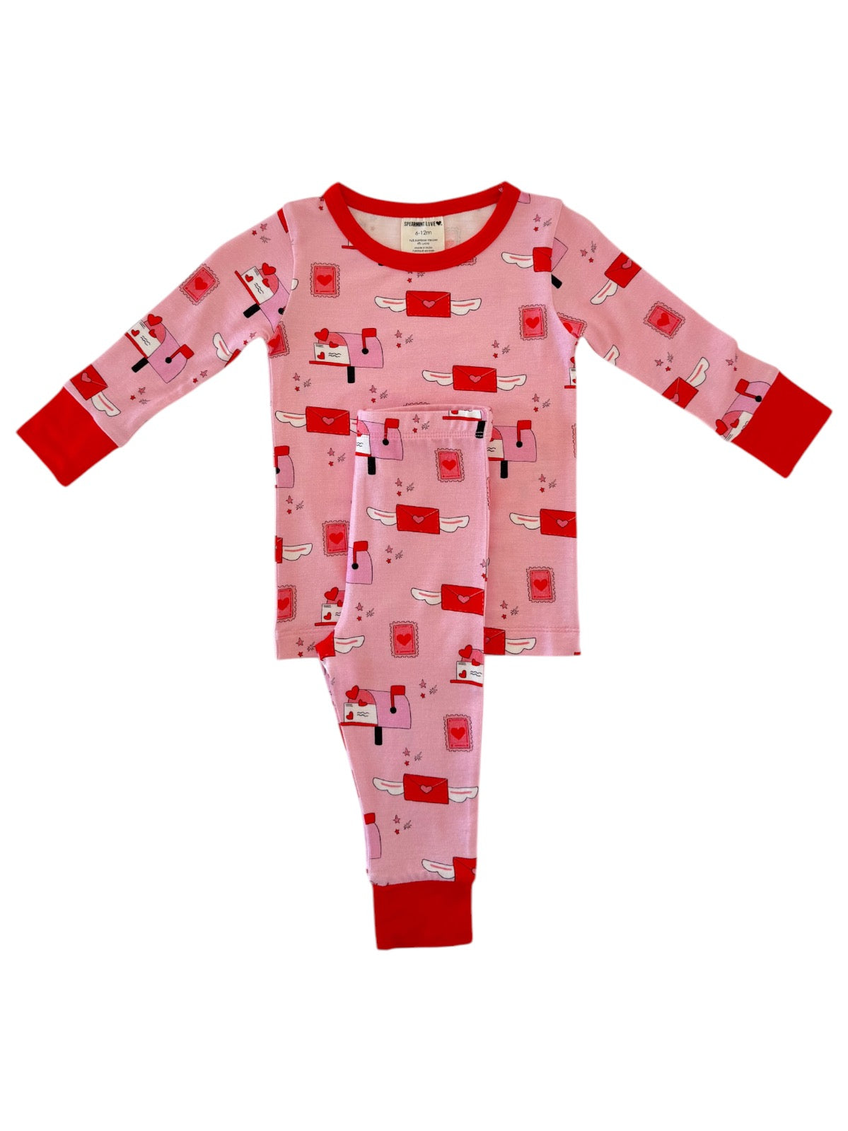 Pink pajamas with red accents featuring a playful mail theme and whimsical envelopes printed throughout.