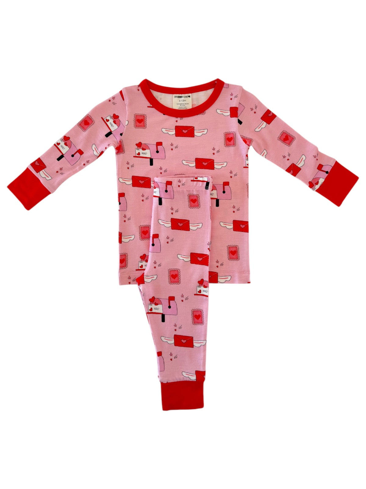 Pink pajamas with red accents featuring a playful mail theme and whimsical envelopes printed throughout.