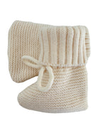 Cozy cream-colored knitted baby booties with a ribbed cuff and tie detail.